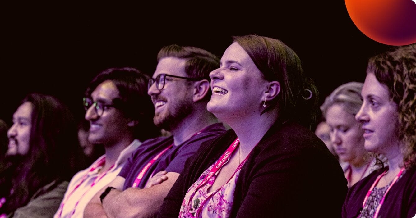 Two people looking at the stage in 3/4 profile