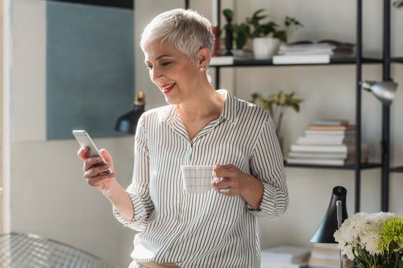 Frau am Handy liest sich Best Practice Leitfaden durch